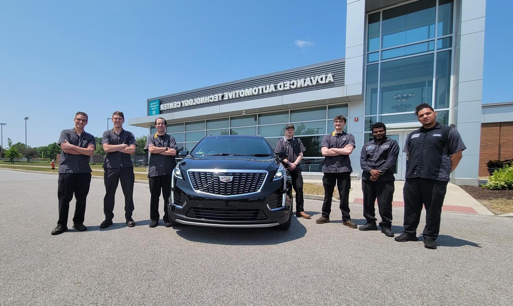 ASEP students with a 2023 Cadillac XT5 donated by GM